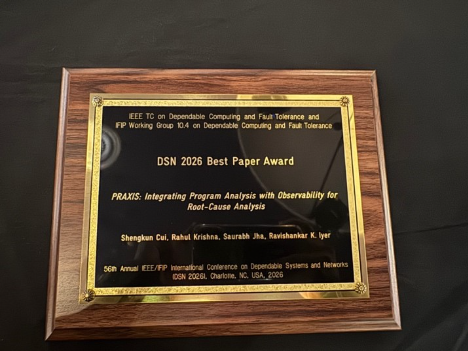 A plaque with gold trim on a black surfaceDescription automatically generated